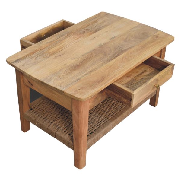 Angled view of oak coffee table with drawer slightly open