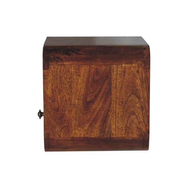 Wooden bedside table side view, dark brown finish, closed drawer.