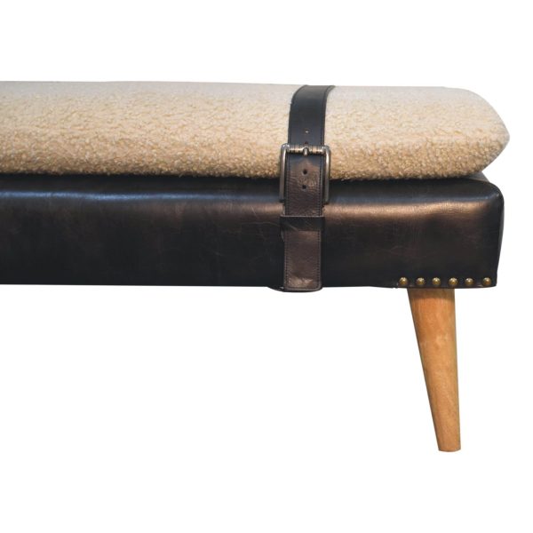 Upholstered bench, side view with black leather and strap.